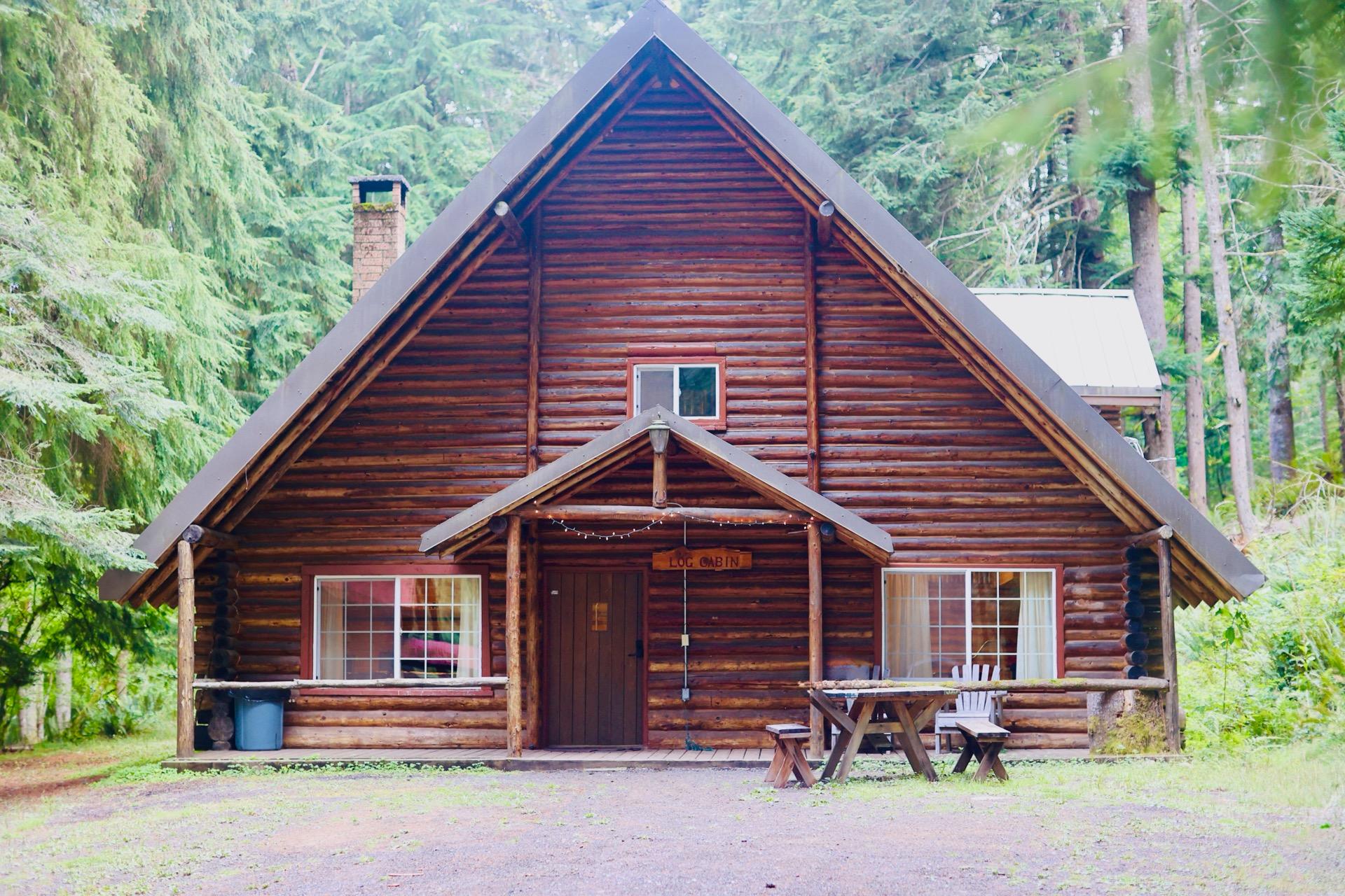 Rainier Lodge Log Cabin exterior surrounded by forest